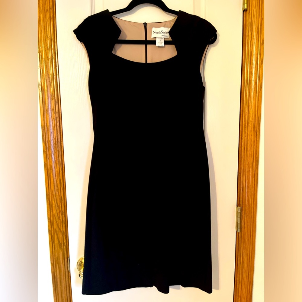 6P sleeveless black party dress, never worn. Unique, flattering neckline.